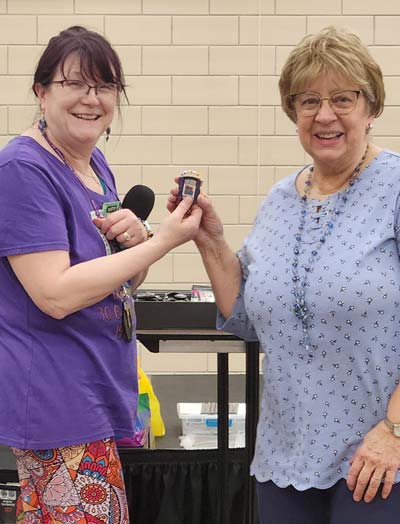 Kathy presents 10 year membership pin to Beverly